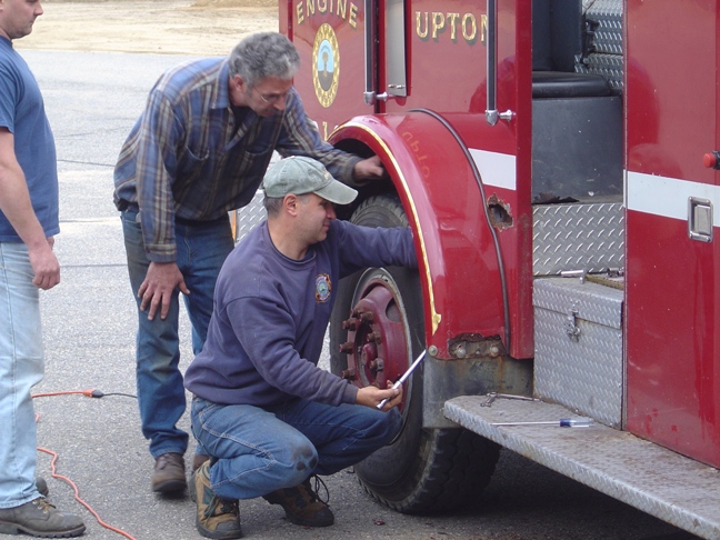 men working on a firetruck